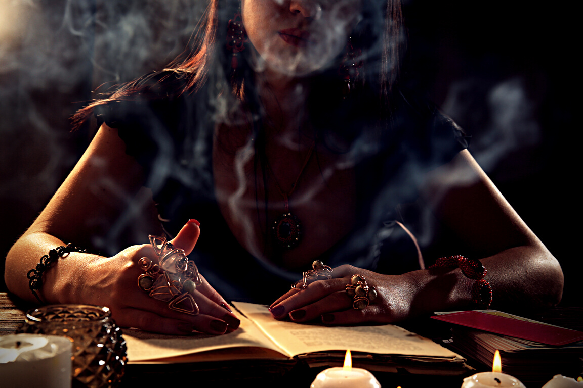 Woman Reading a Book at a Table Surrounded by Smoke